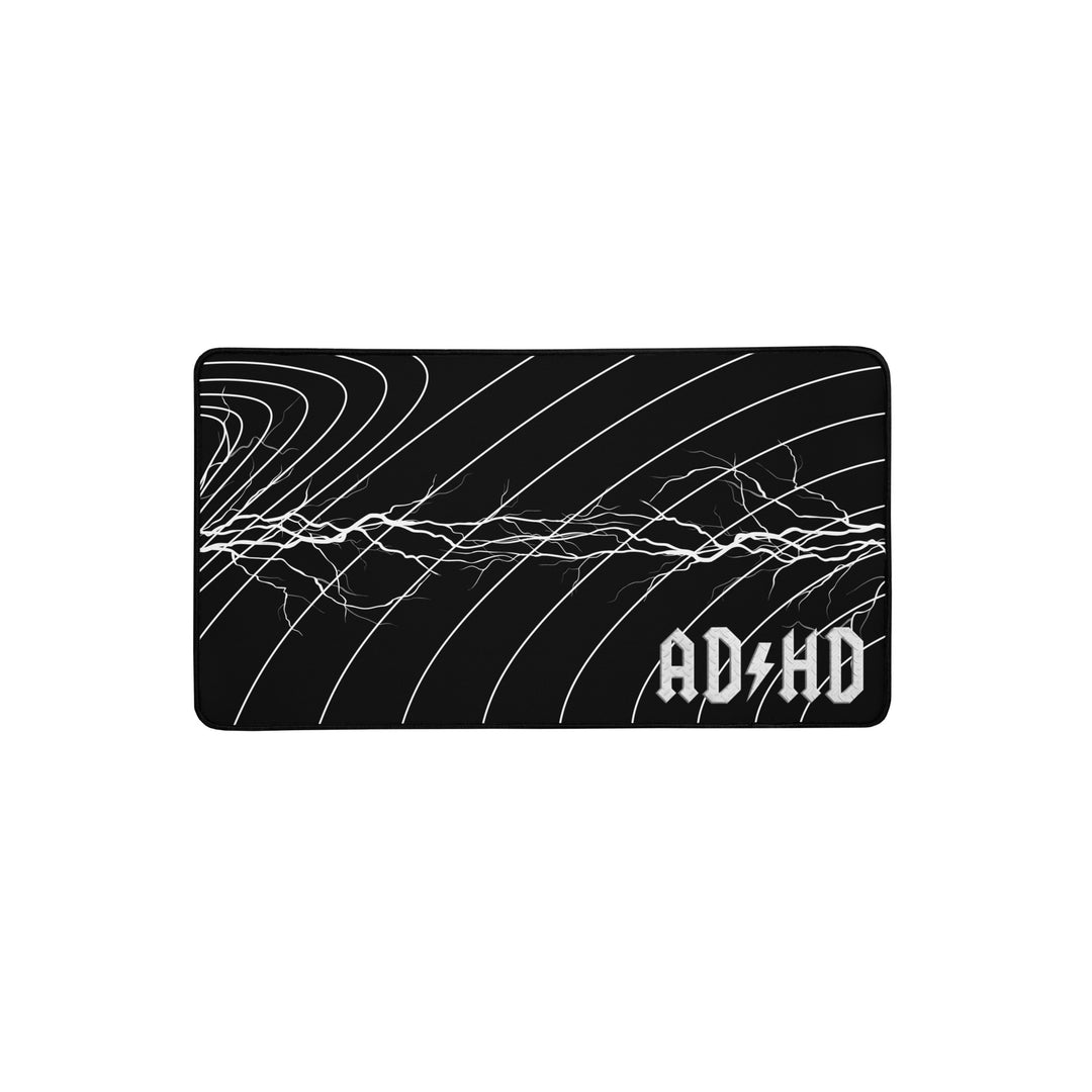 Black AD/HD High Voltage desk mat featuring an electric lightning pattern and gold logo, designed for gaming, coding, and high-energy workspaces.