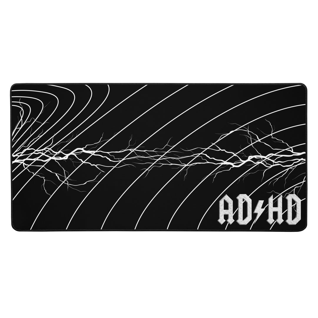 Black AD/HD High Voltage desk mat featuring an electric lightning pattern and gold logo, designed for gaming, coding, and high-energy workspaces.