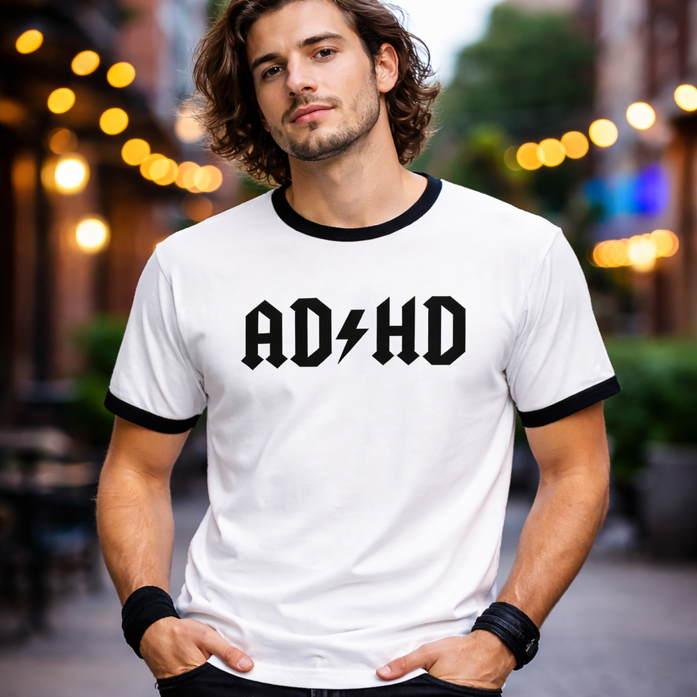 Model wearing a white and black ringer t-shirt featuring the AD/HD High Voltage lightning logo, styled for a modern geek aesthetic.