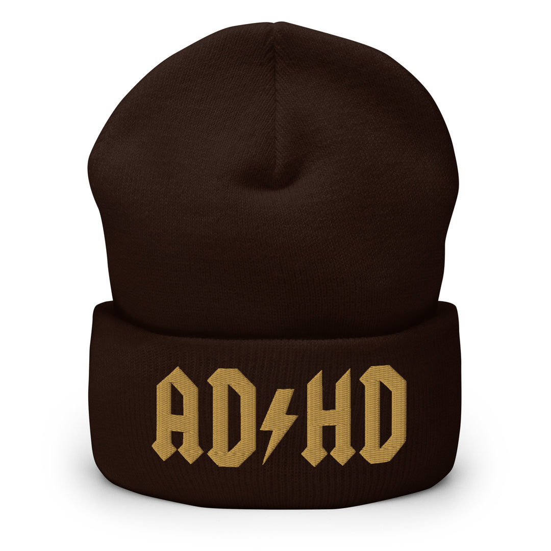 Brown cuffed beanie embroidered with the AD-HD lightning bolt design in old gold, inspired by classic rock iconography and high-voltage energy.