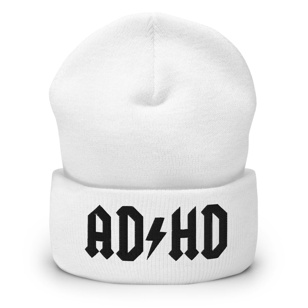 White cuffed beanie embroidered with the AD-HD lightning bolt design in black, inspired by classic rock iconography and high-voltage energy.