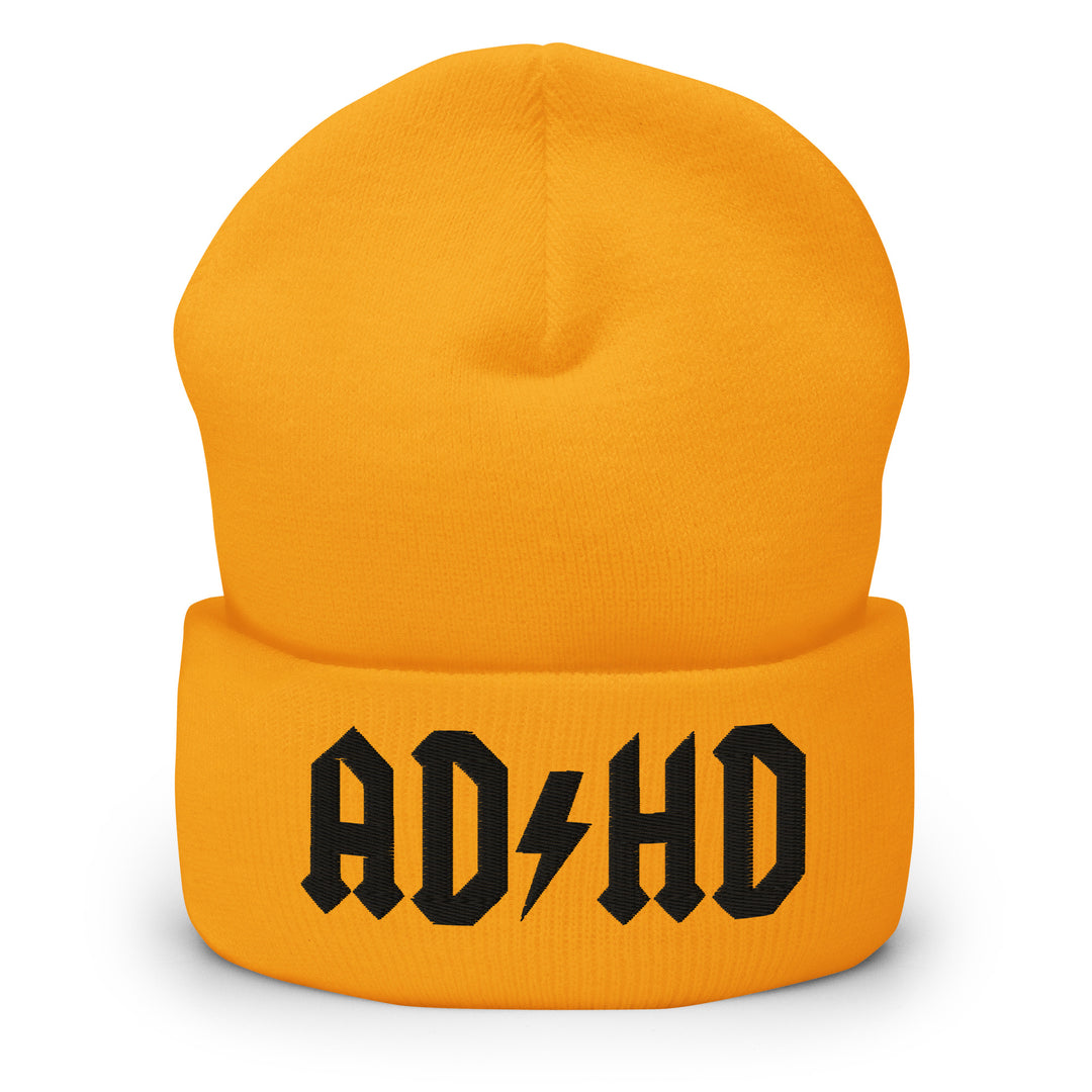Yellow cuffed beanie embroidered with the AD-HD lightning bolt design in black, inspired by classic rock iconography and high-voltage energy.