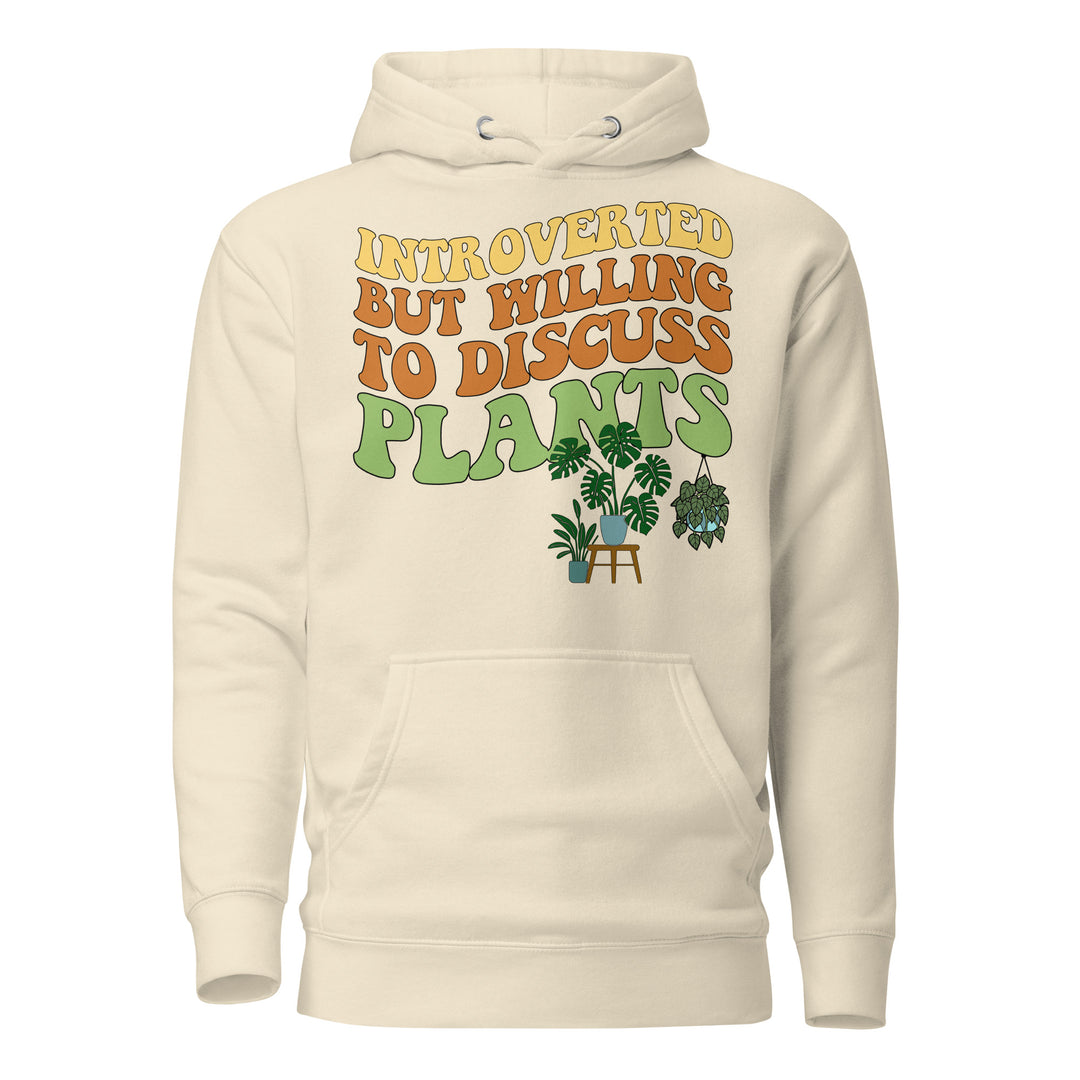 Front view of the beige “Introverted but Willing to Discuss Plants” hoodie with retro lettering and illustrated houseplants.