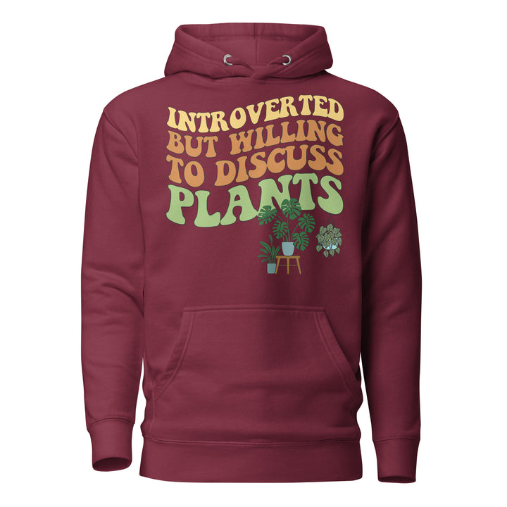 Front view of the maroon “Introverted but Willing to Discuss Plants” hoodie with retro lettering and illustrated houseplants.