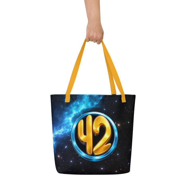 Back view of the Keep It Geek 42 cosmic tote bag with yellow handles, featuring a glowing gold “42” inside a metallic blue circle against a vibrant nebula starfield design.