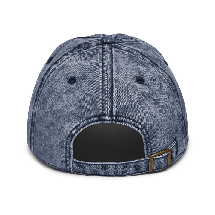 Back view of a vintage denim dad cap with adjustable strap and antique brass buckle
