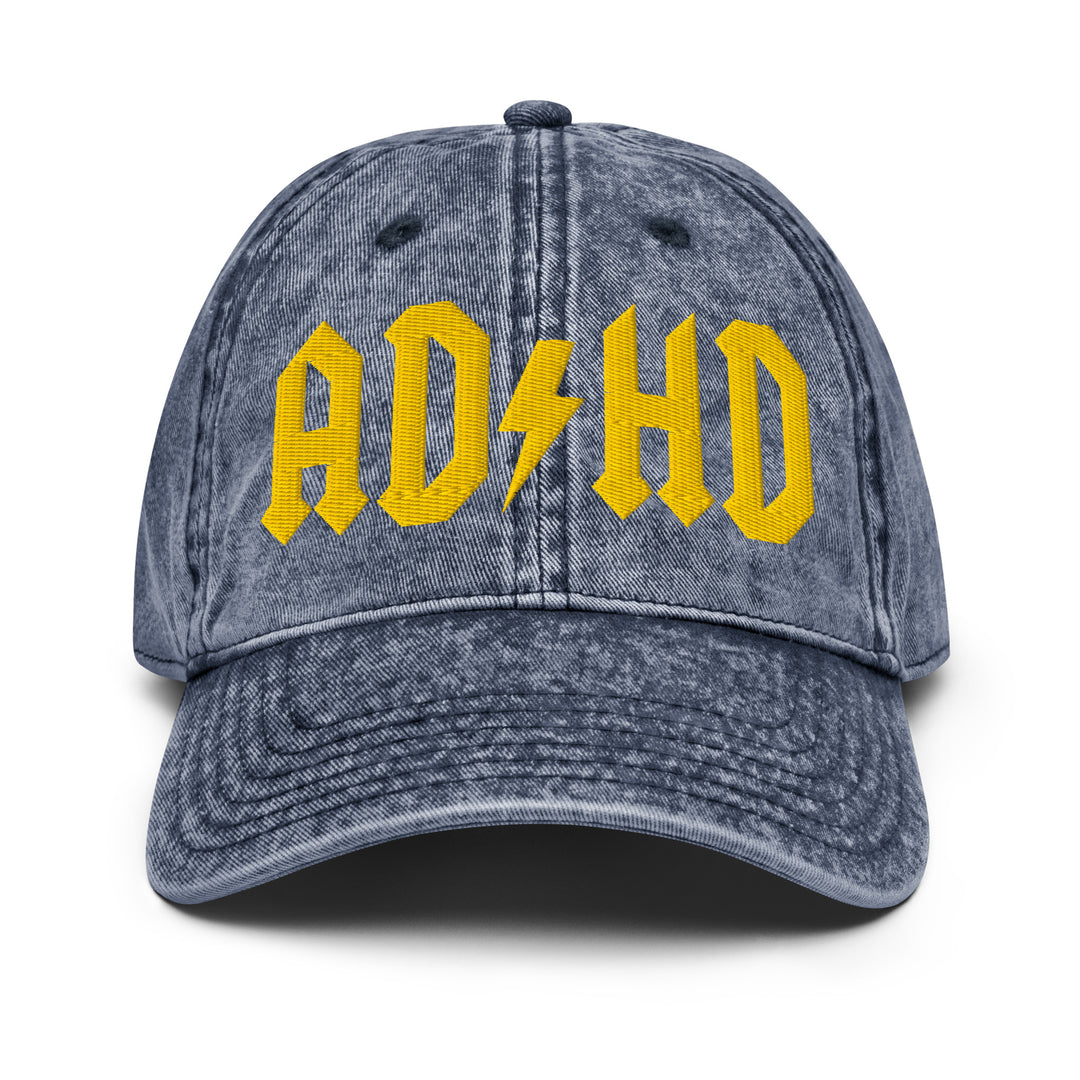 Front view of a vintage denim dad cap featuring AD/HD High Voltage embroidery