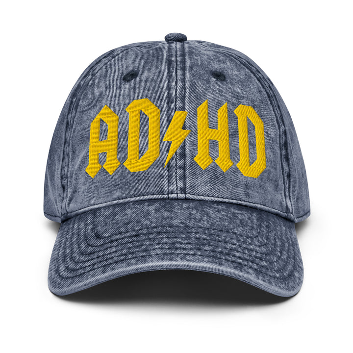 Front view of a vintage denim dad cap featuring AD/HD High Voltage embroidery