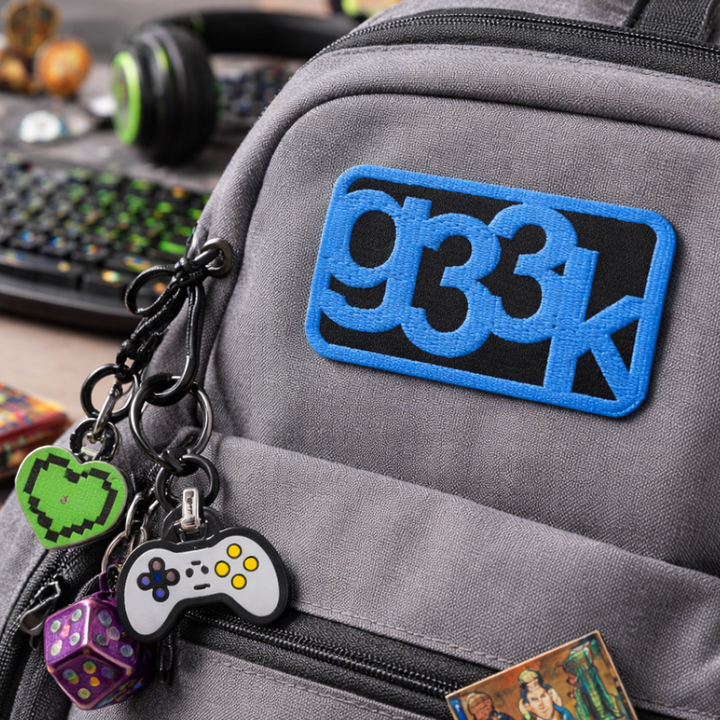Embroidered g33k leetspeak patch attached to a backpack in a casual everyday lifestyle setting