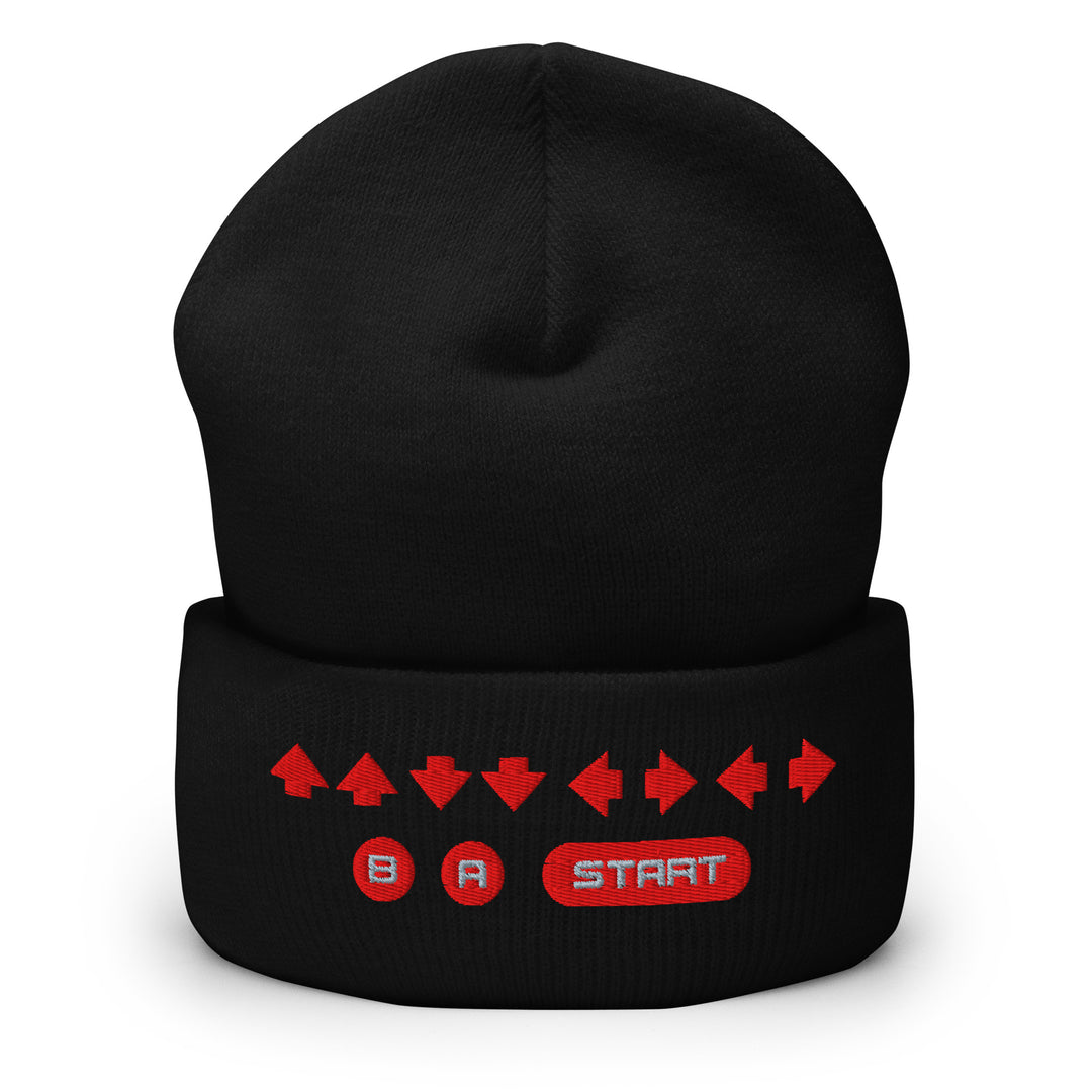 Front view of a black cuffed beanie with embroidered retro cheat code arrow sequence and B, A, START icons across the cuff.