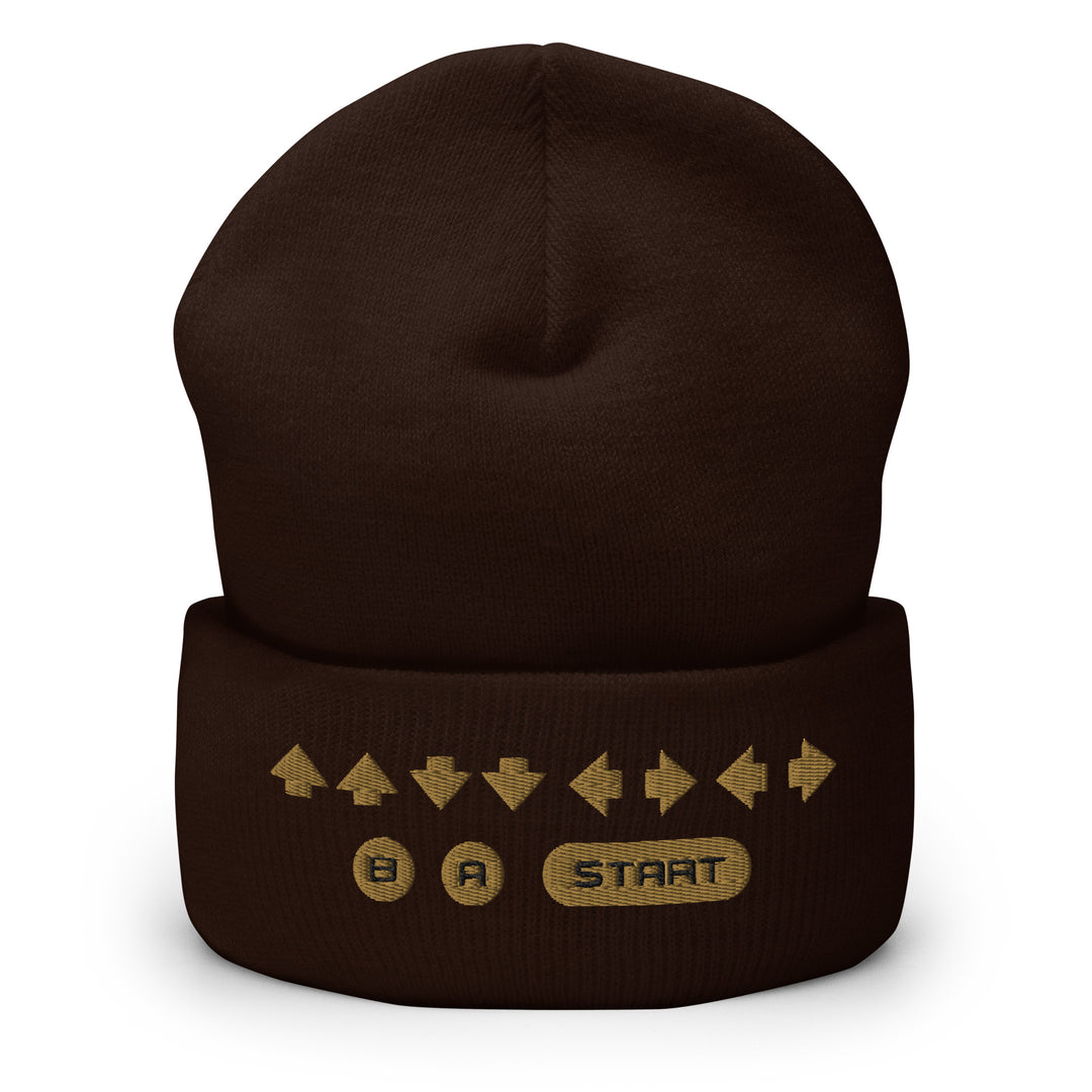Front view of a brown cuffed beanie showcasing embroidered retro cheat code arrows and B, A, START icons on the cuff.