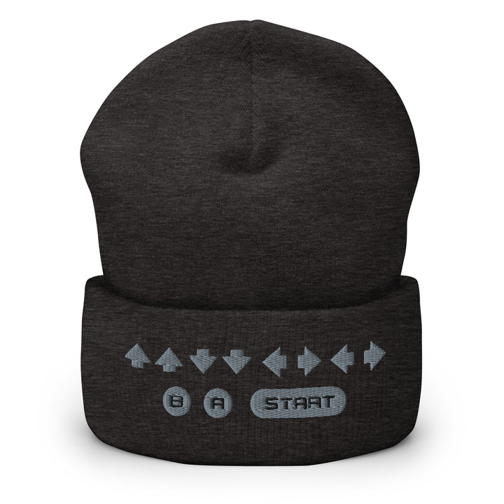 Front view of a charcoal cuffed beanie featuring embroidered retro cheat code arrows with B, A, and START icons on the folded cuff.