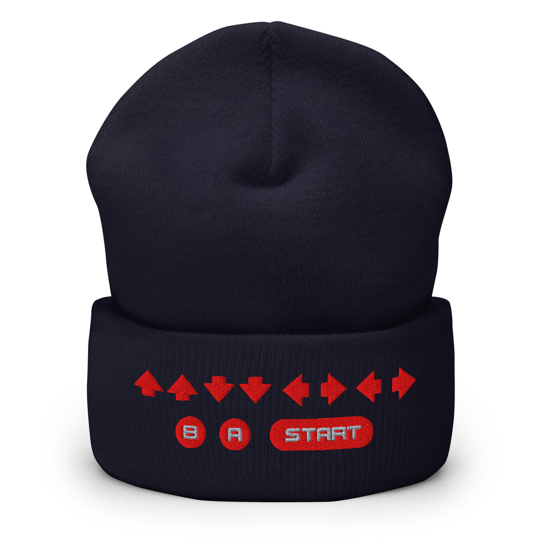 Front view of a navy cuffed beanie with embroidered retro cheat code arrow sequence and B, A, START symbols across the cuff.