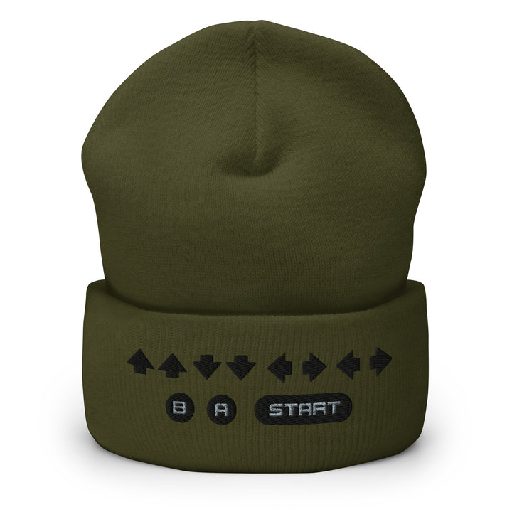 Front view of an olive cuffed beanie featuring embroidered retro cheat code arrows with B, A, and START icons across the folded cuff.