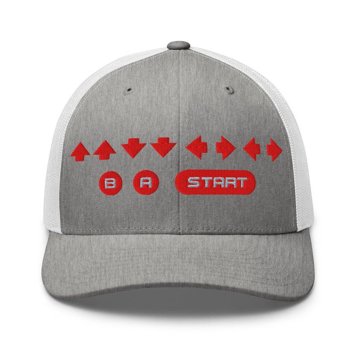 Front view of a heather gray and white snapback trucker cap with red embroidered retro cheat code arrows and B A START buttons on the front panel