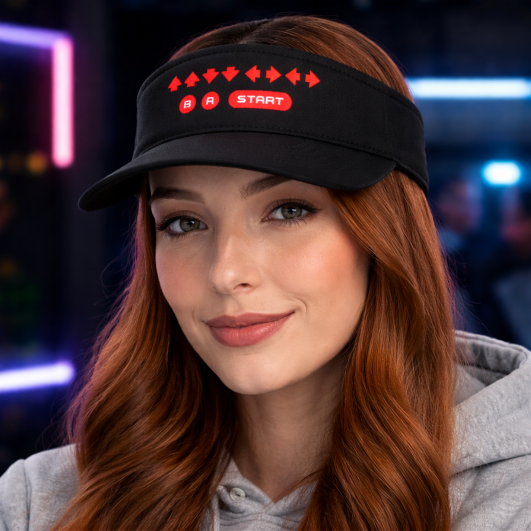 Retro Cheat Code Embroidered Visor shown on a model, featuring crisp red embroidered directional arrows with B, A, and START icons on a black low-profile visor in a square lifestyle mockup