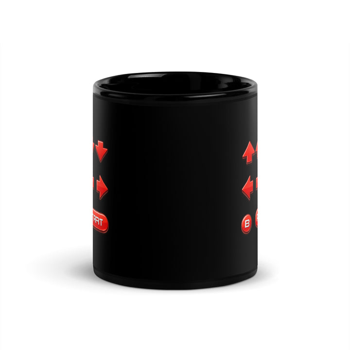 Opposite-handle view of an 11 oz black ceramic mug showing the retro cheat code design wrapping across both sides of the mug.