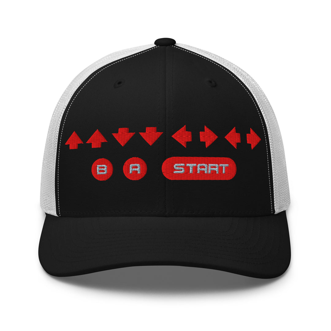 Front view of a black and white mesh trucker cap with red embroidered directional arrows and B A Start button symbols