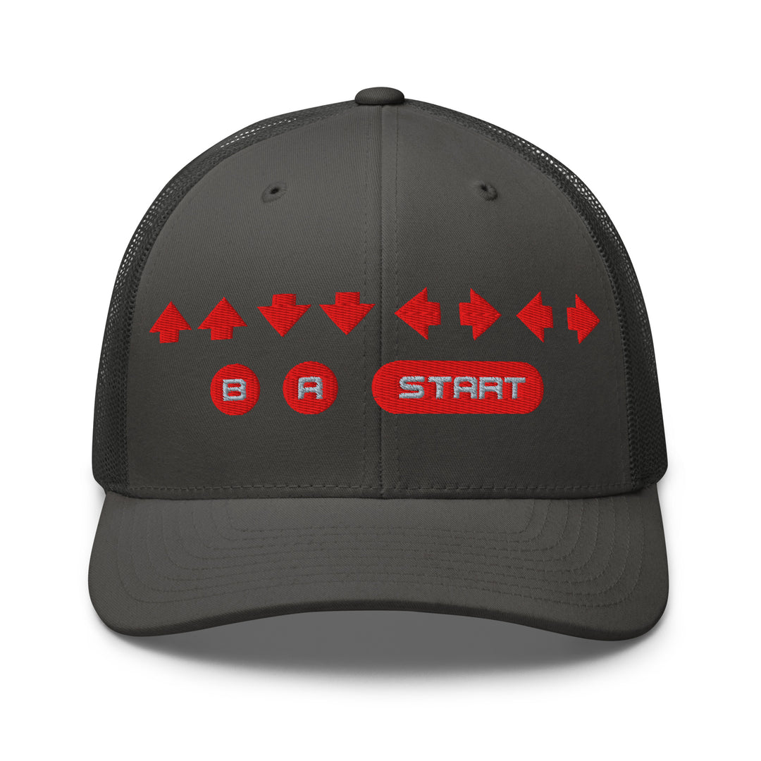 Front view of a charcoal gray mesh trucker cap with red embroidered directional arrows and B A Start button symbols