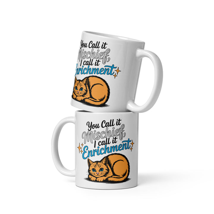 Stacked variant mockup showing both sides of the Keep It Geek “You Call It Mischief, I Call It Enrichment” orange cat glossy coffee mug in the 11 oz size, featuring logo-matched blue typography and an illustrated orange cat on a white ceramic mug.