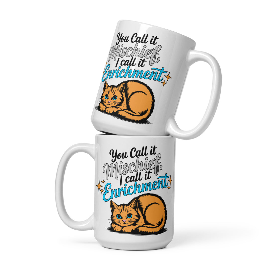 Stacked variant mockup showing both sides of the Keep It Geek “You Call It Mischief, I Call It Enrichment” orange cat glossy coffee mug in the 15 oz size, featuring logo-matched blue typography and an illustrated orange cat on a white ceramic mug.