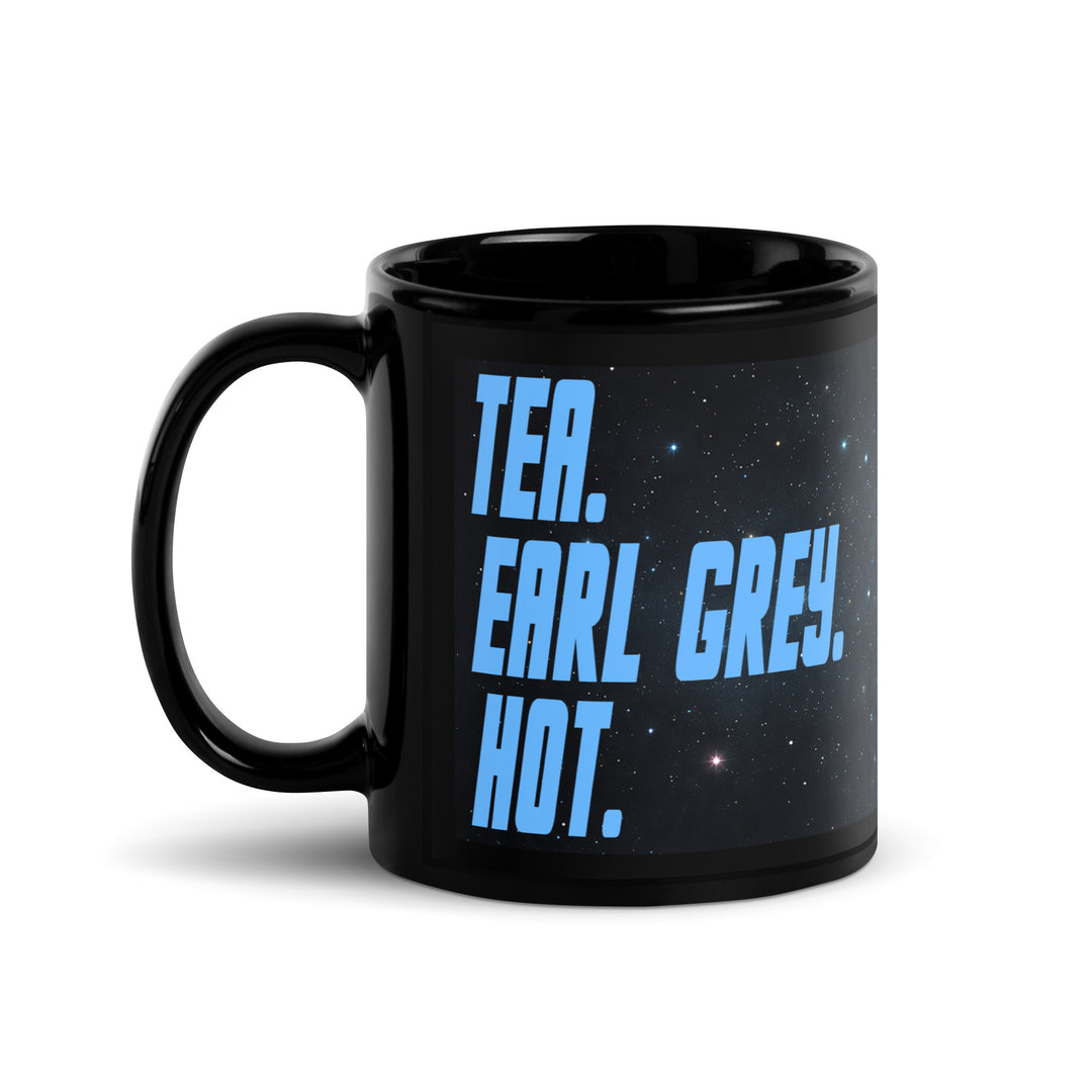 Alt: Black 11 oz glossy mug with “Tea. Earl Grey. Hot.” design shown from the left-handle angle.