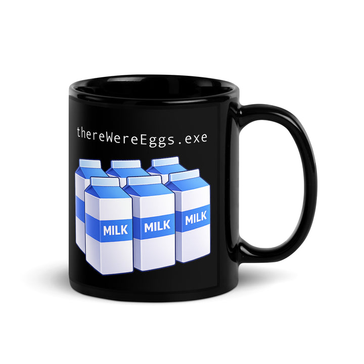 Black ceramic coffee mug featuring the text “thereWereEggs.exe” above six blue-and-white milk cartons, a subtle programmer inside joke design.